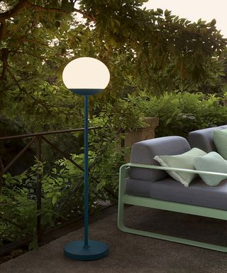 Moon lamp beside outdoor seating in long garden