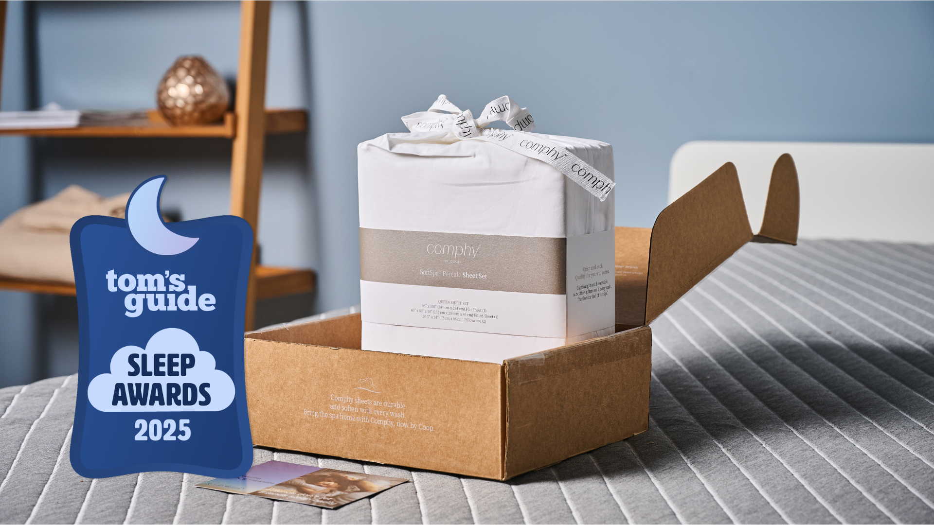 Coop Cotton Percale sheet set in the packaging placed on the bed in TG Sleep studio wit the TG Sleep Awards badge on the left 