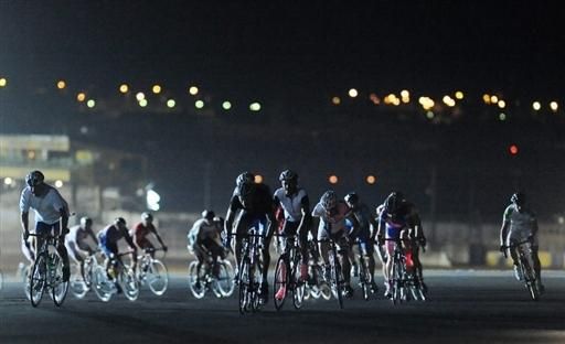 A group sticks together as they tackle the darkness between flood lights.