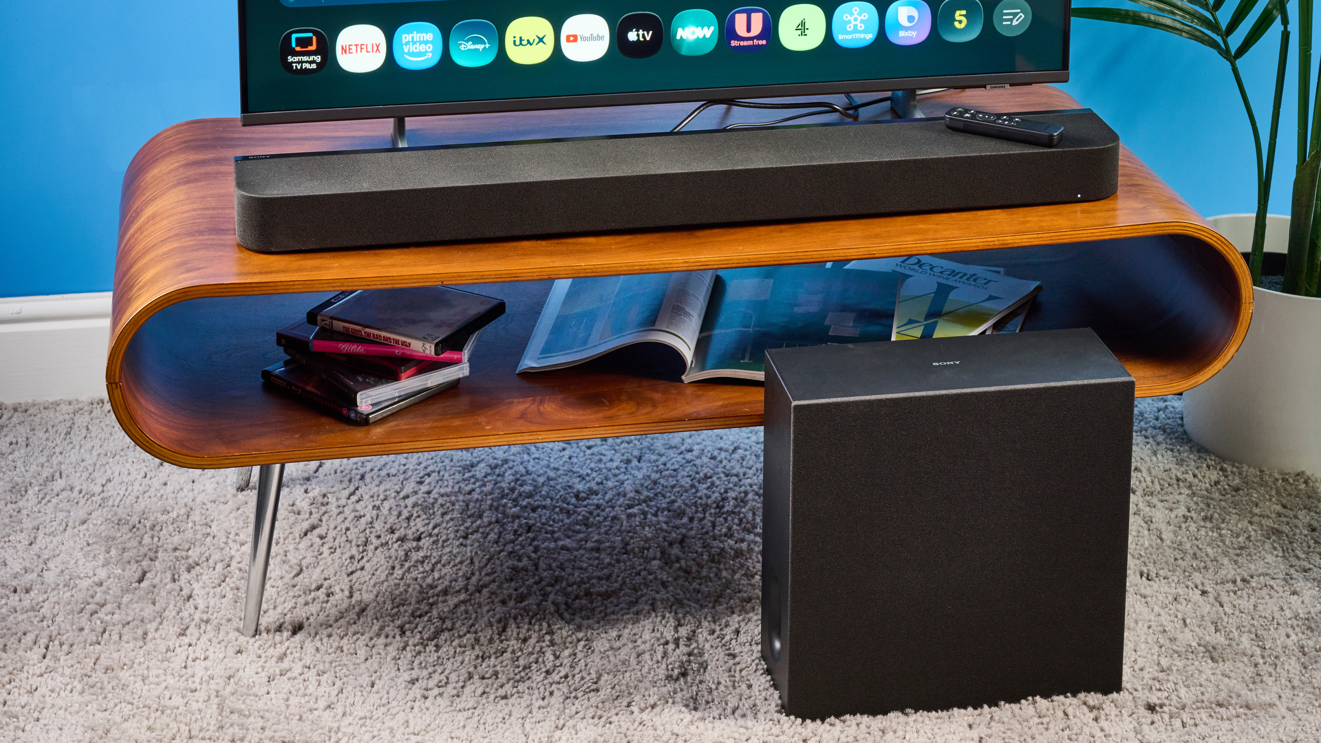 the sony bravia theater bar 7 photographed with the subwoofer with a TV on the tom's guide blue background