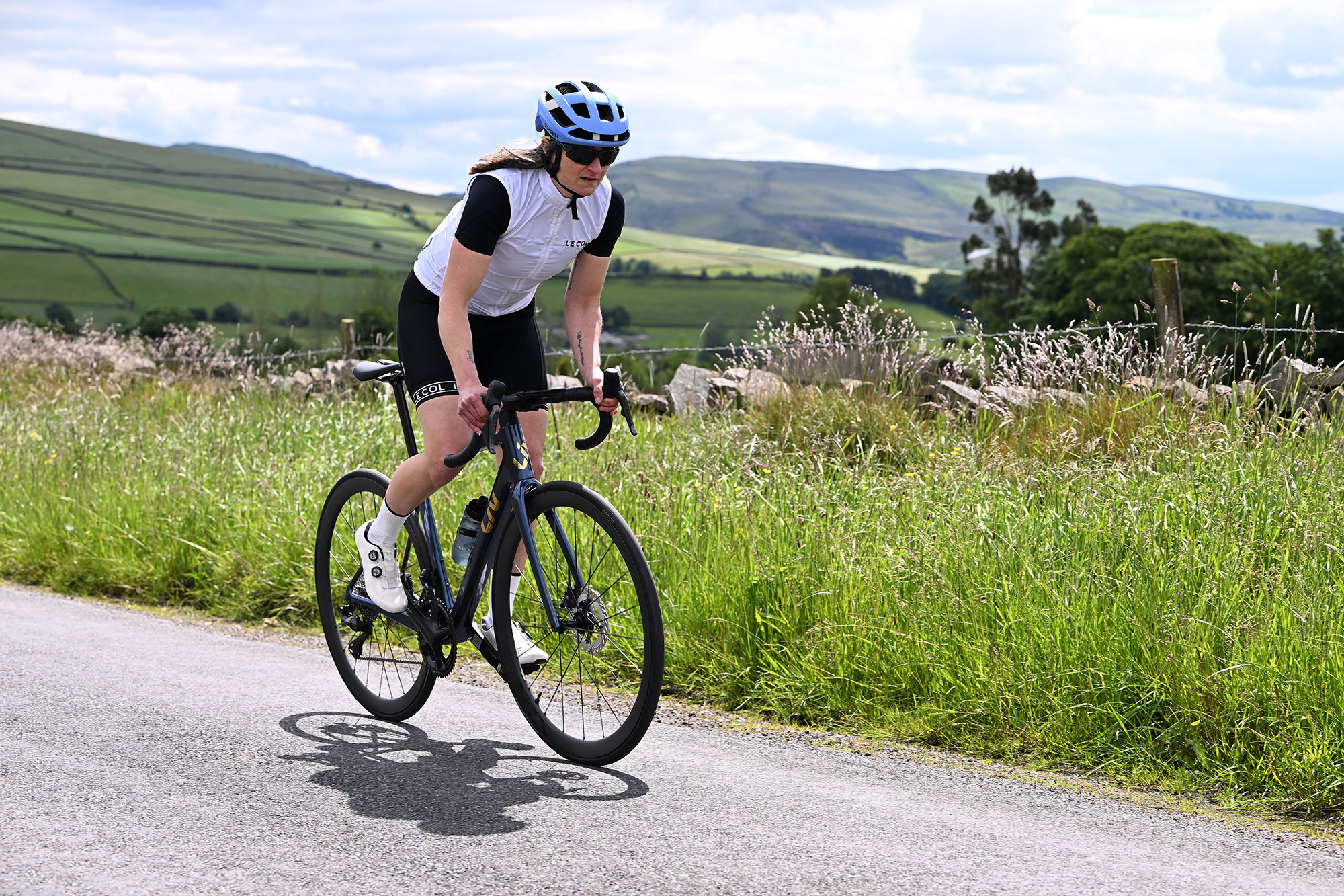 Woman riding up hill on Liv Langma bike