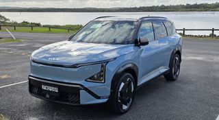 The Kia EV5 parked by a lake