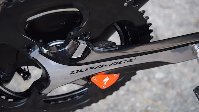 A close up look at the Specialized power meter. A few other pro bikes have also been seen with a fluoro orange hardware cover