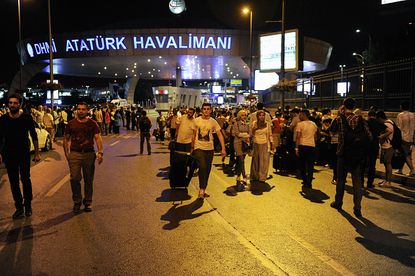 Passengers leave Turkey's Ataturk Airport after deadly blasts Tuesday.