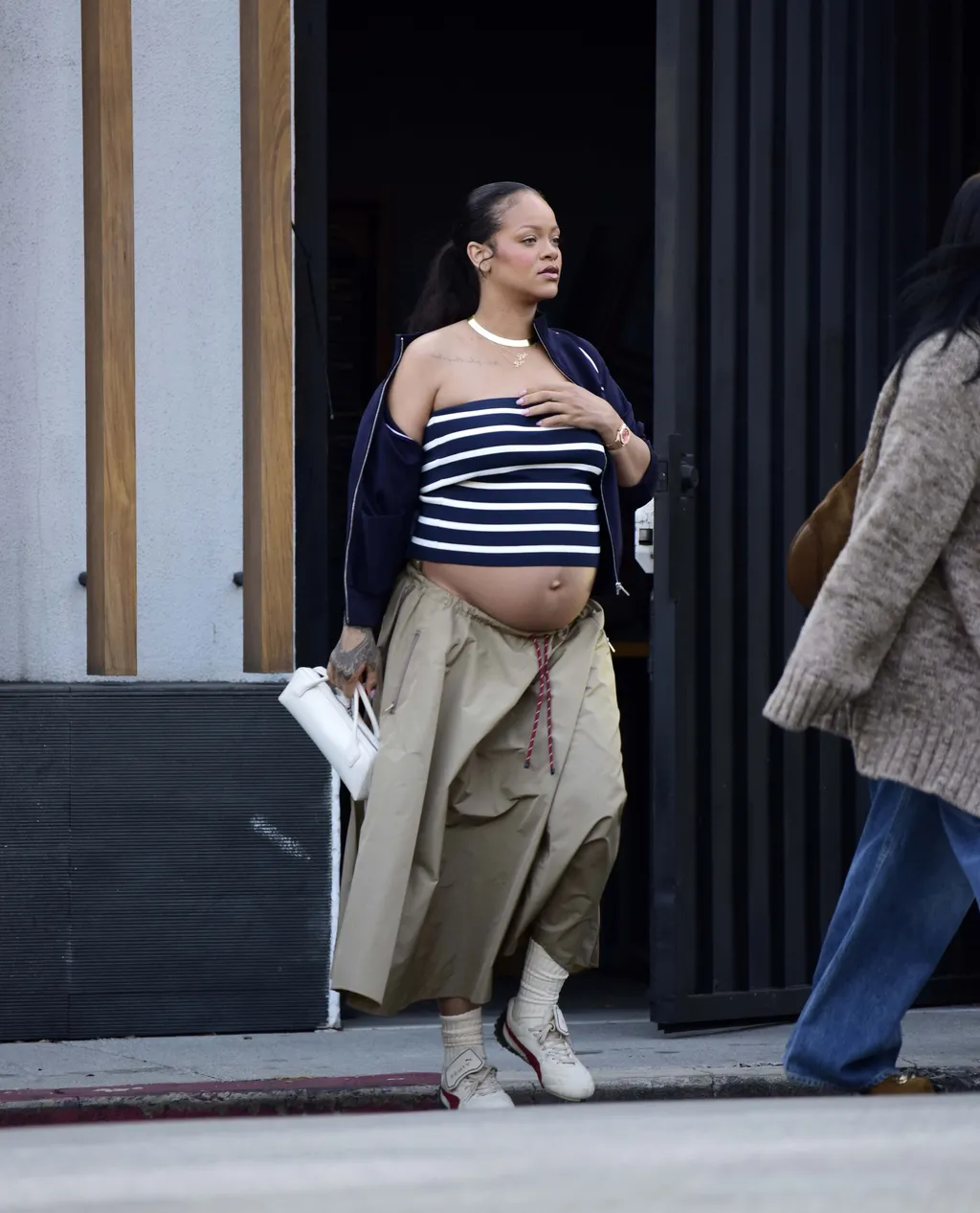 Rihanna wearing a tube top with a cargo skirt and sneakers