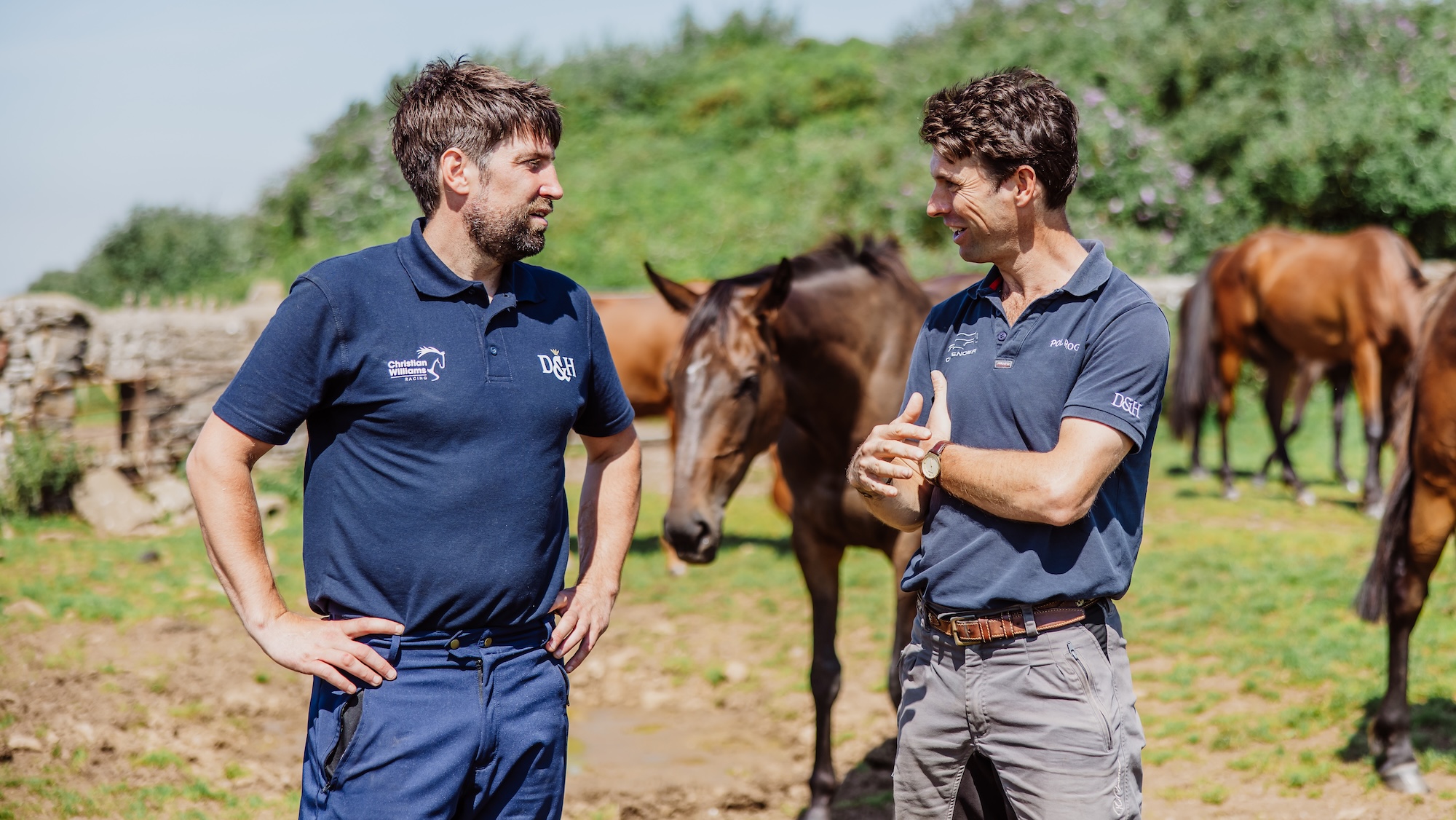 Christian Williams and Harry Meade chatting in a field of horses