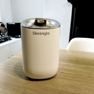 The Silentnight 39899 dehumidifier being tested on a wooden table in a kitchen