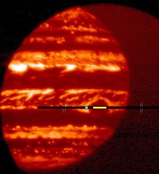 The Great Red Spot is the dark patch in the middle of this infrared image of Jupiter. It is dark due to the thick clouds that block thermal radiation. The yellow strip denotes the portion of the Great Red Spot used in astrophysicist Gordon L. Bjoraker’s analysis.