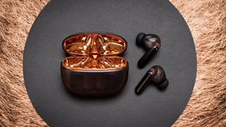 Creative Aurvana Ace 2 earbuds next to the case