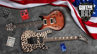Multiple guitars and effects pedals lying on the floor with an American flag