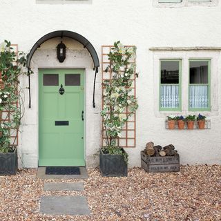 house with green coloured paint door and windows