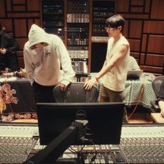 A group of people work in a recording studio, in the Netflix documentary 'BTS: The Return." Pictured, from left: PDogg, Suga, RM, V, unknown, and Jin.