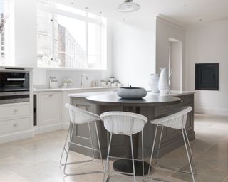 Grey and white kitchen ideas with a grey island and white cupboards around the edge