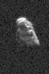 a grainy pixelated rock is spinning in black space.