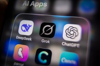 In this photo illustration a iPhone screen displaying the Grok app and logo is seen besides the logos for other AI apps including DeepSeek and ChatCPT (Photo by Anna Barclay/Getty Images)