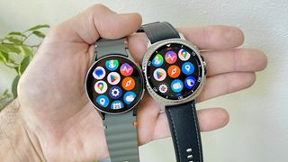 Close-up of the Samsung Galaxy Watch 7 and Galaxy Watch 8 Classic in a user's hand showing the app screens
