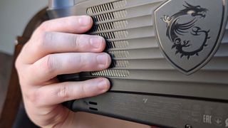 Fingers on the backside of the MSI Claw 8 AI+.