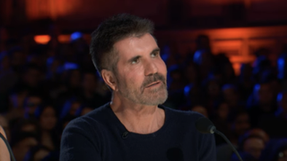 Simon Cowell looking at Putri Ariani singing on America's Got Talent Season 18