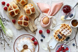 Easter breakfast display with hot cross buns, waffles and jams.