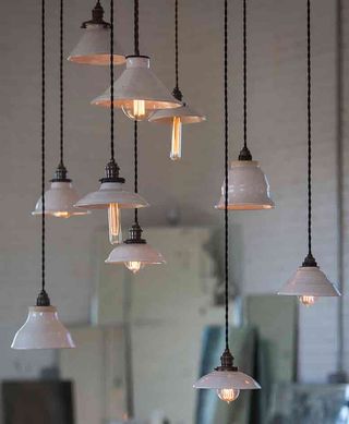 Lights formed from ceramic bowls and funnels and lit using a variety of sizes and shapes of bulb