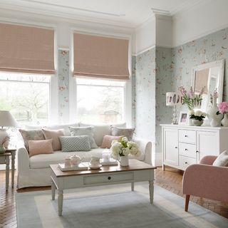 living room white sofa and bird print wallpaper on wooden flooring