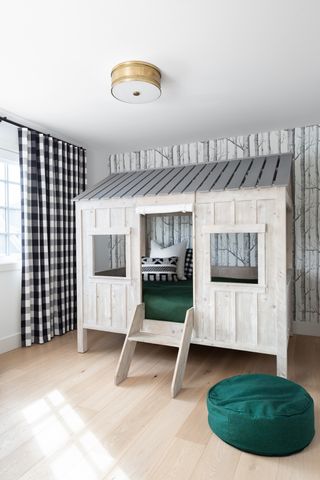 A bedroom with a bed designed like a house