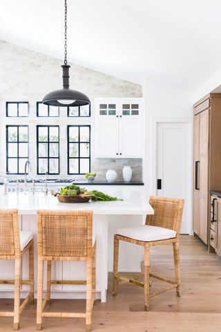 white kitchen with rattan kitchen stools by Lindye Galloway