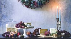Festive table with cheese, grapes and crackers on