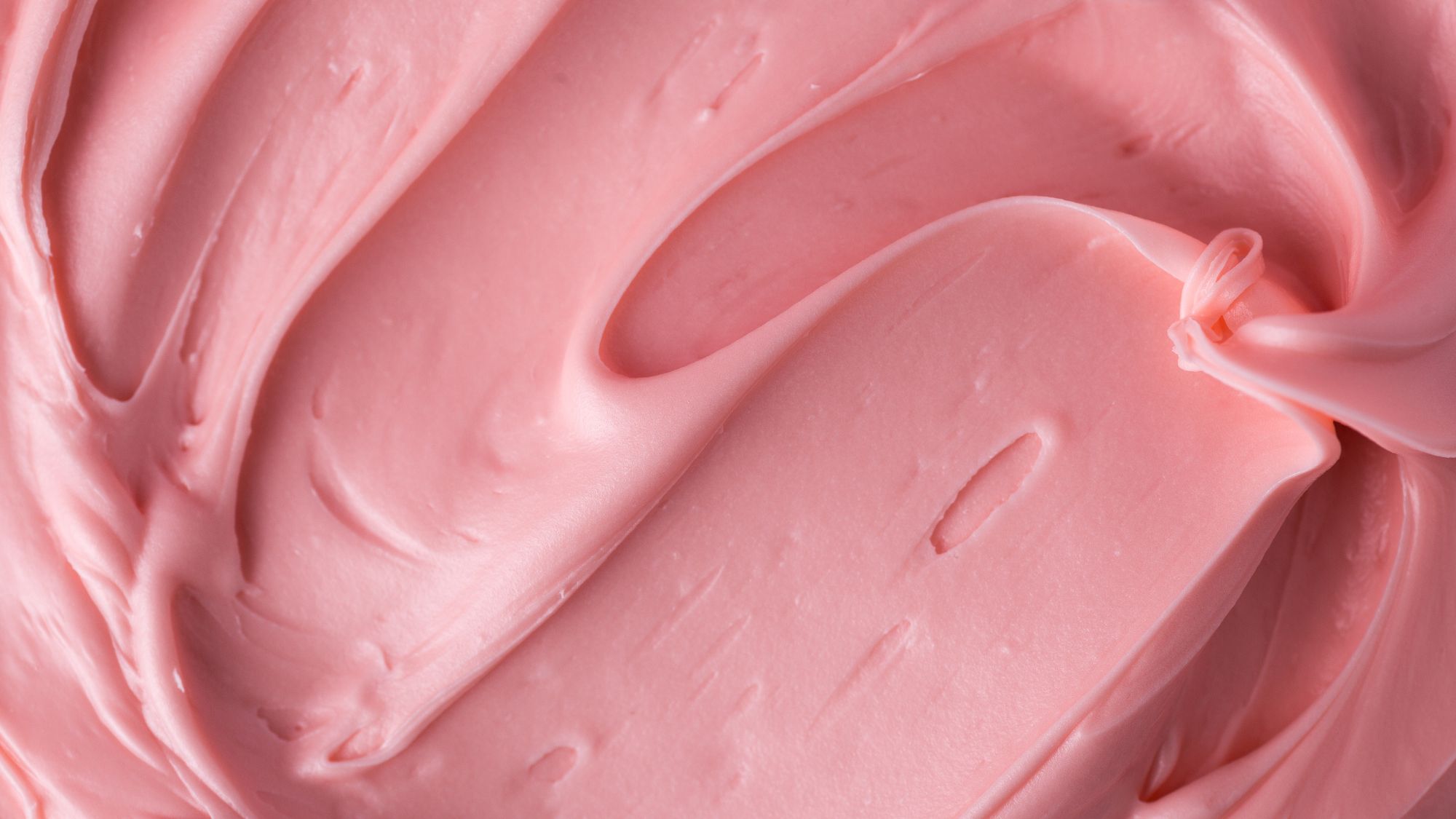 A close up of pink frosting in a mixing bowl: Signs you're eating too much sugar