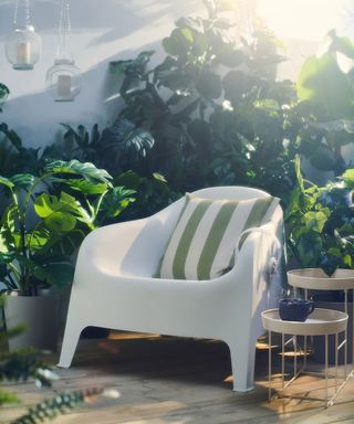 skarpoe armchair outdoor white by IKEA in a patio area with striped cushion