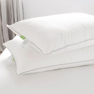 White Scooms pillow on a white bed