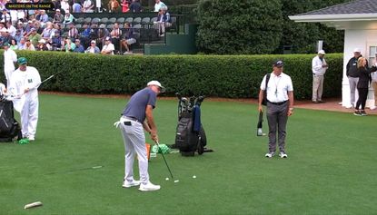 Mickelson uses his putter on the driving range at Augusta National