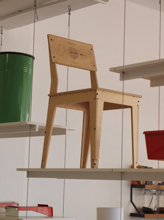 Wooden chair stood on a white shelf