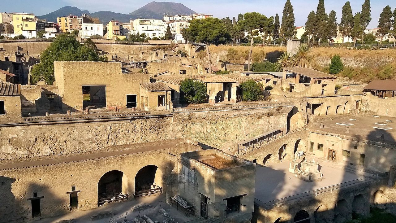 A photo of the ancient Herculaneum site with Mt. Vesuvius in the background