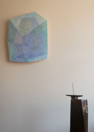 Light blue wall piece and a wooden plinth with incense dish