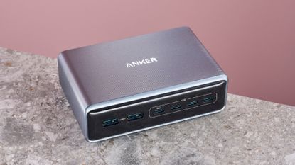 Anker Prime Charger (200W, 6 ports, GaN) on stone surface against pink background