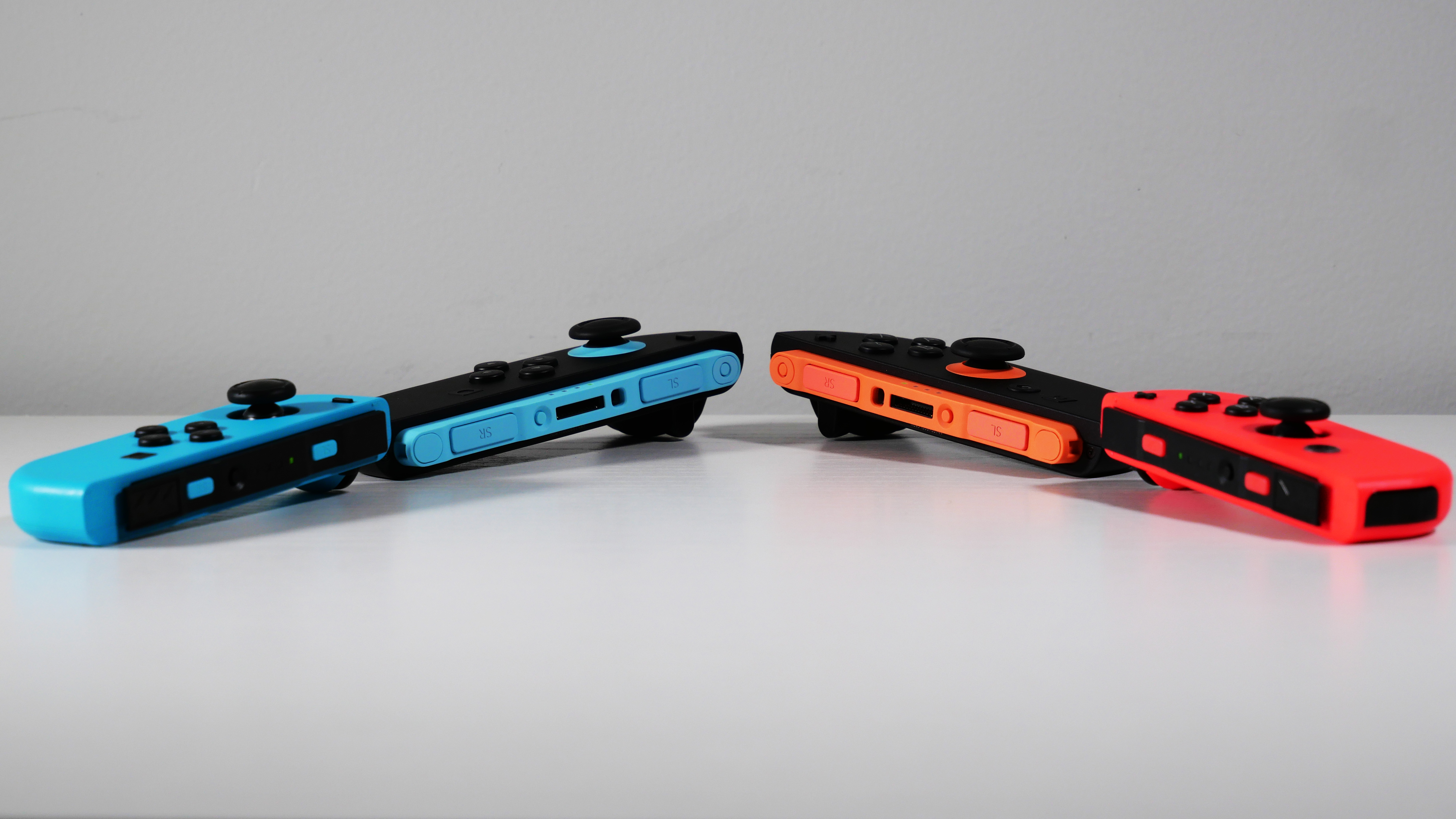 Nintendo Switch 2 and Switch OLED Joy-Con controllers side by side.