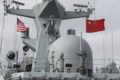 Chinese and American flags fly on the Chinese Navy frigate called Yancheng in San Diego on December 6, 2016 during a four day visit to California.