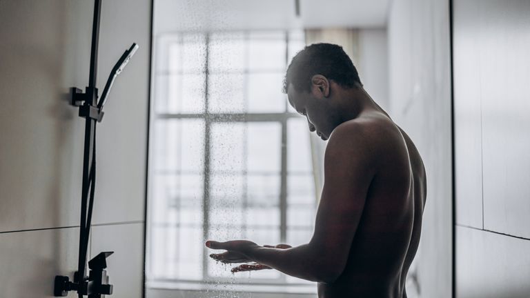 Man in the shower, contemplating whether to use hair conditioner