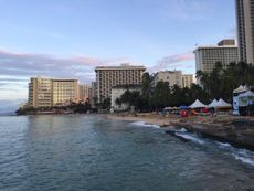 People take in the partial solar eclipse on Waikiki Beach on Oahu.
