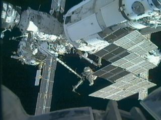 Russian cosmonaut Anton Shkaplerov (right) rides the Strela crane outside the International Space Station during a 6-hour, 15-minute spacewalk with crewmate Oleg Kononenko on Feb. 16, 2012. The cosmonauts moved the Strela crane to a different spot on the 