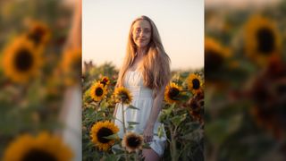 Woman standing in a sunflower field