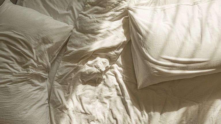 Messy White Sheet On Bed - stock photo