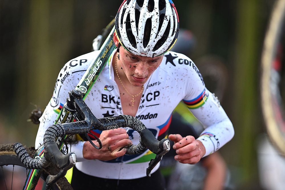 Mathieu van der Poel shoulders his bike.