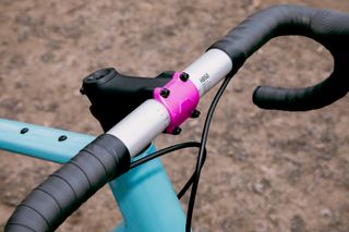 The Canyon Grizl CF SL 7 Throwback bars with a black stem, pink plate and black bar tape