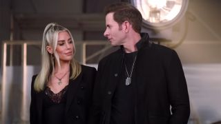 Clip from interview with Tarek and Heather Rae El Moussa staring lovingly at one another, both wearing black.