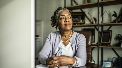 Portrait of senior woman at desktop computer in home office