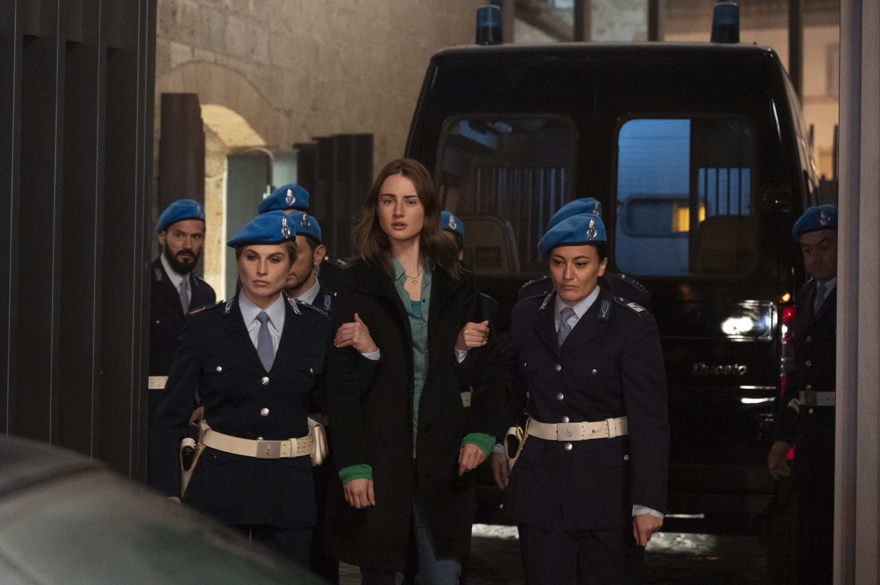grace van patten as amanda knox being escorted by italian police in the twisted tale of amanda knox