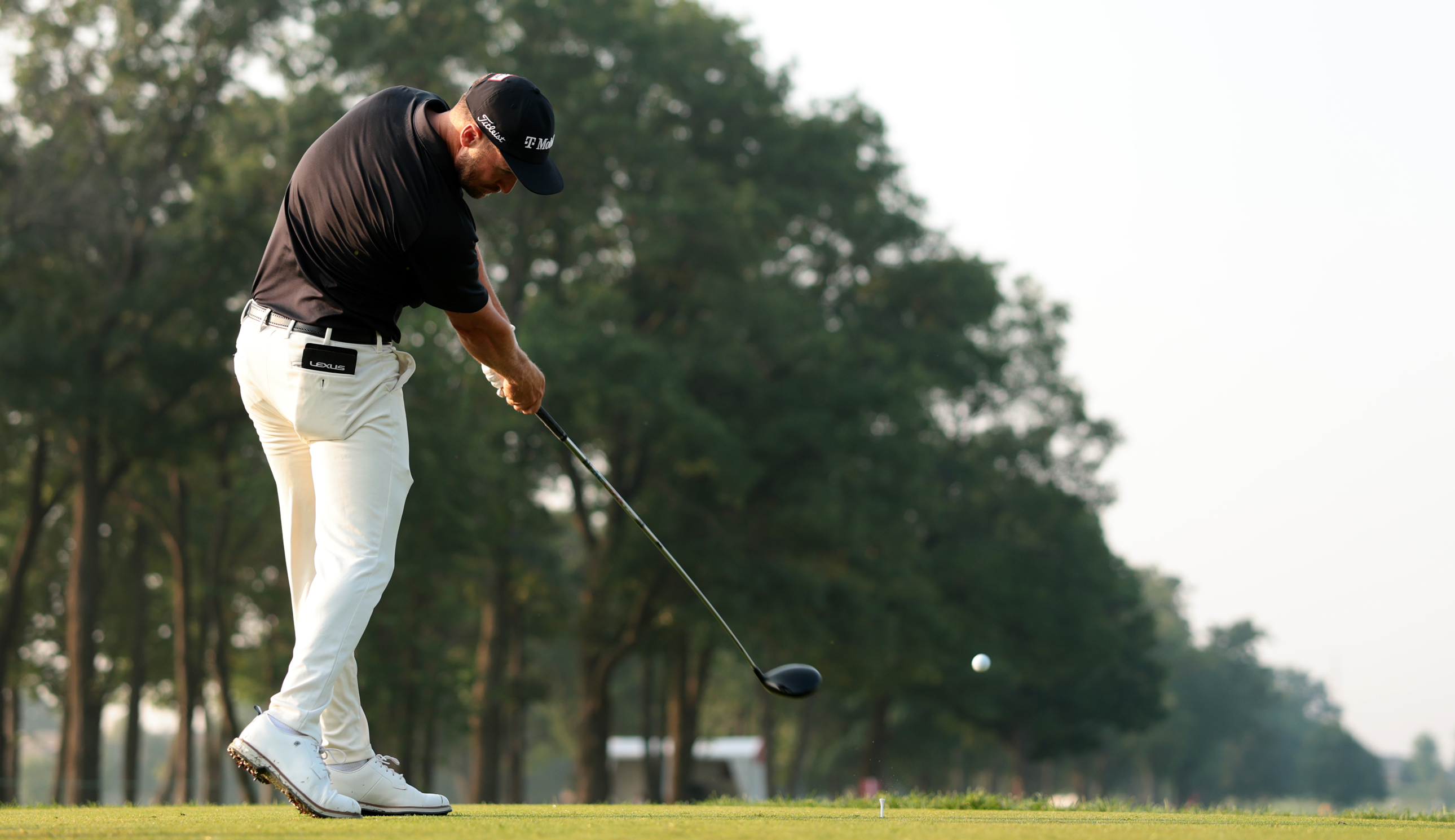 Wyndham Clark strikes a tee shot with a driver