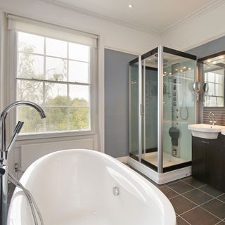 bathroom with bathtub and glass shower door